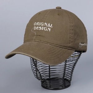 Detail of white 3D letter embroidery on olive cotton baseball cap displayed on a stand