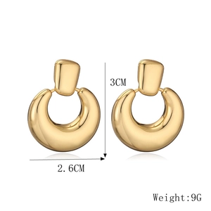 Detail view of gold geometric crescent earrings with 3cm height and 2.6cm width measurements