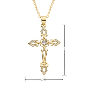 Macro shot of gold cross pendant with cubic zirconia inlay and size dimensions