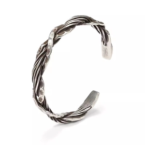 Handcrafted silver cuff bracelet with vintage hammered texture and braided wire design