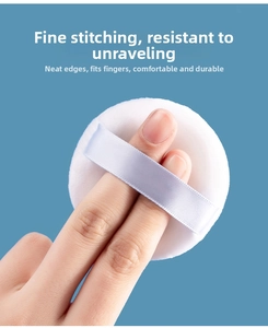 Detailed view of white powder puff showing high-quality stitching and finger-fitting design