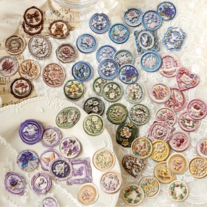 Embossed letter seal stickers with floral designs in various colors for scrapbooking