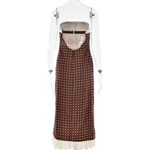Detail of a brown polka dot maxi dress featuring a low back design and white ruffled hem