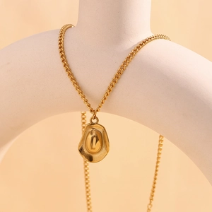 Detailed close-up of a 18K gold-plated stainless steel cowboy hat pendant necklace