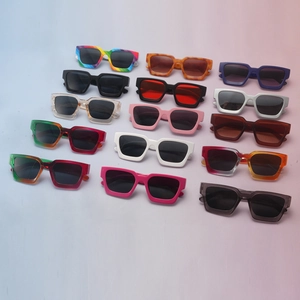 Flat lay of 15 colorful thick-frame square sunglasses in assorted vibrant fashion colors
