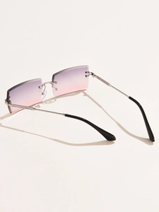 Detail of rimless square sunglasses with purple-pink gradient lenses and silver metal temples