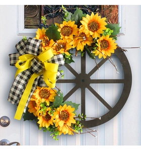 Detail of sunflower wreath with buffalo plaid bow on a rustic wooden wagon wheel