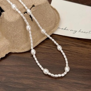 Minimalist 925 sterling silver pearl necklace with natural freshwater pearls on wood