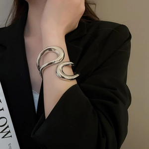Irregular silver geometric hollow cuff bracelet on model with black suit