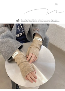 Detail of oatmeal knitted fingerless gloves featuring a nice moment woven fabric label