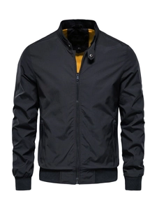 Detail of black casual jacket featuring a contrast yellow lining and ribbed stand collar