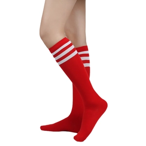 Close-up of bright red knee-high socks with white triple stripes and knit texture