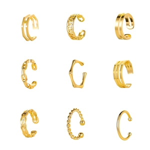 Set of nine golden C-shaped ear cuffs featuring chain, twist, and H-letter designs