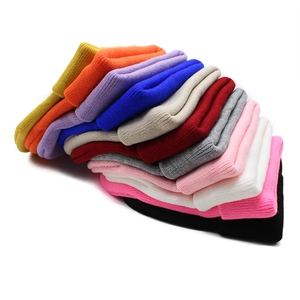 Close-up of assorted colorful ribbed knit beanies showing detailed fabric texture