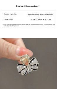 Detailed close-up of a 2.4cm gold bow hair clip with rhinestones and black enamel finish