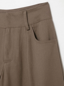 Détail du pantalon cargo marron taille haute montrant le sergé et les surpiqûres