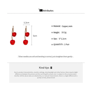 Macro view of cherry resin earrings with size and weight specifications on white background