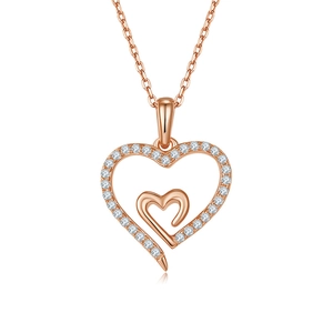 Detailed view of rose gold heart pendant necklace with shimmering white pavé moissanite stones