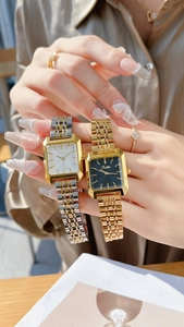 Detail of square gold and silver metal wristwatches with sleek five-link bracelets