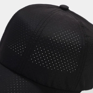 Detailed close-up of breathable mesh fabric on a black quick-dry sport baseball cap