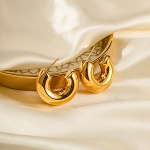 Close-up of chunky 18K gold plated stainless steel hollow C-shaped hoop earrings