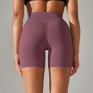 Detail of high-waist purple yoga shorts showing V-shaped back seam for butt lifting