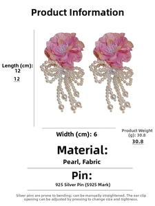 Detail view of 12cm oversized floral earrings with faux pearl bows and long tassels