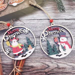 Detail of wooden Christmas ornaments featuring reindeer and snowman with rustic pine decor