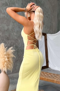 Detail of cross tie backless design and ruched details on a yellow maxi dress