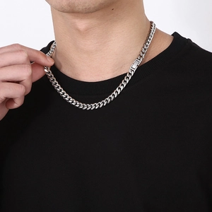Polished silver titanium steel Cuban link chain necklace worn on a male model