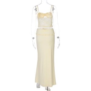 Detail of light yellow lace crop top and long skirt set on transparent mannequin