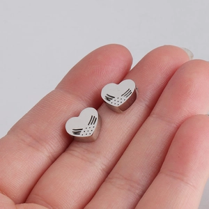 Polished silver stainless steel heart pendants with hollow angel wing textured patterns
