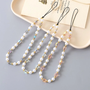 Close-up of beaded phone lanyards with white pearls, crystals, and gold beads in fan shape