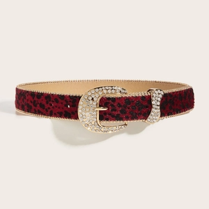 Red leopard print belt with rhinestone oval buckle and gold beaded trim on cream background