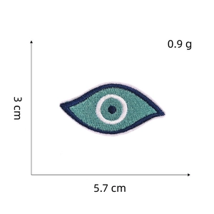 Detailed view of evil eye embroidered patch with 5.7cm dimensions and blue silk thread