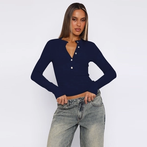 Close-up of navy knit Henley shirt featuring a ribbed texture and multi-button neckline