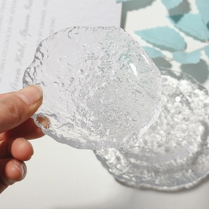 Detail shot of irregular clear glass tray with ice-like texture for jewelry photography