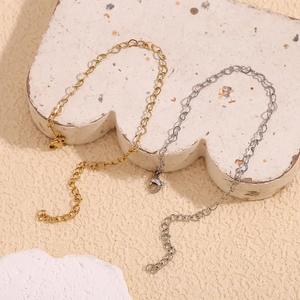 Detail of heart chain bracelet in gold and silver finish with adjustable lobster clasp