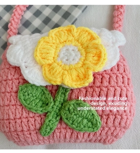 Close-up detail of handmade crochet mini flower shoulder bag featuring cute knit floral leaf pattern.