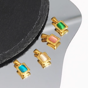 Macro shot of colorful square zircon pendants in gold finish on a black stone base