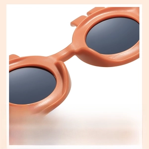 Close-up of integrated nose pads on orange matte kids sunglasses for comfortable fit