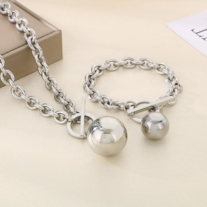 Close-up of silver titanium steel chain set with large ball pendant and toggle clasp