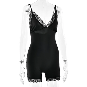 Detailed close-up of delicate black lace trim on the V-neckline of a sleek bodysuit