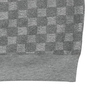 Macro shot of gray knitted checkerboard pattern fabric with ribbed bottom cuff detail