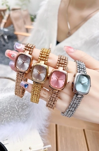 Wrist view of women's square metal link watches in gold, rose gold, silver and pink tones