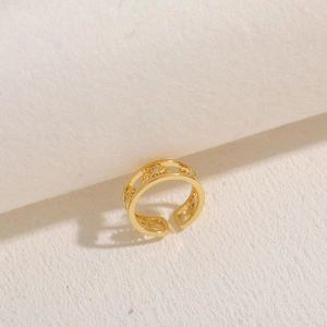 Macro view of adjustable gold-plated star and moon ring with inlaid cubic zirconia