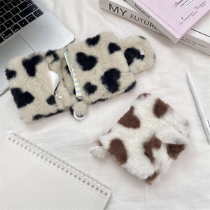 Macro shot of plush heart pouches for earphones showing fuzzy texture and zip detail