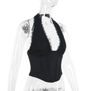 Detailed view of black lace halter top with deep V-neck and corset style boning details