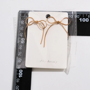 Detailed size measurement of golden bow earrings showing a 35mm width and 50mm length
