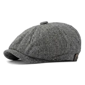 Classic herringbone tweed newsboy cap for men and women in grey 45-degree side view